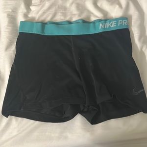 Black Nike pro shorts with blue waistband